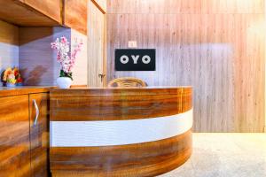 a wooden counter with a sign on a wall at Hotel O New Star Guest House in Behāla