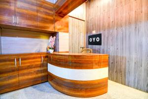 a room with a wooden wall with a large wooden desk at Hotel O New Star Guest House in Behāla