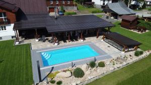 an overhead view of a house with a swimming pool at Chalet Schäfer s vyhřívaným bazénem se slanou vodou a saunou in Harrachov