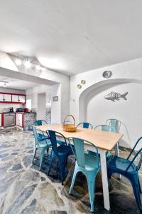 a dining room with a table and blue chairs at Casa do Loureiro in Alandroal