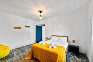 a bedroom with a bed with a yellow blanket at Casa do Loureiro in Alandroal +63 photos