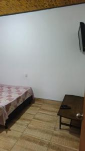 a bedroom with a bed next to a table at Natural country house in Guarne