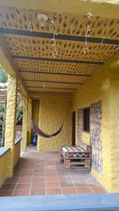 a porch with a hammock on a yellow building at Natural country house in Guarne