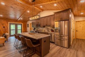 a kitchen with a large kitchen island with a stainless steel refrigerator at Deer Valley in Elk Park