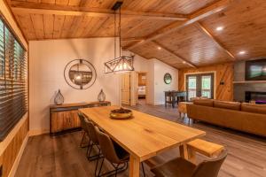 a dining room with a table and a couch at Deer Valley in Elk Park +17 photos