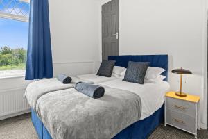 a bedroom with two beds and a window at Haydock Contractor House, 2-Bed, Easy M6 Access in Haydock