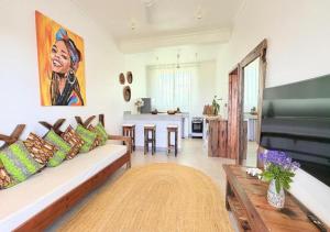 a living room with a couch and a table at Zanziland Apartments in Kiwengwa