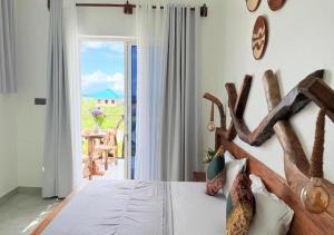 a bedroom with a bed with a wooden head board at Zanziland Apartments in Kiwengwa +29 photos