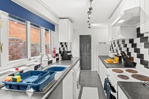 a kitchen with a sink and a counter top at Haydock Contractor House, 2-Bed, Easy M6 Access in Haydock