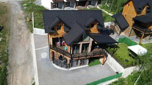 an overhead view of a house with a black roof at LUX PINE house in Zlatibor