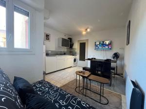 a living room with a couch and a table at Studio avec piscine à 1km de la plage in Cavalaire-sur-Mer