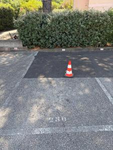 a traffic cone sitting in the middle of a parking lot at Studio avec piscine à 1km de la plage in Cavalaire-sur-Mer