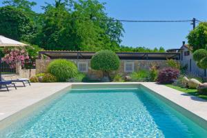 a swimming pool in a yard with a house at Villa Morgan by Rent Istria in Umag