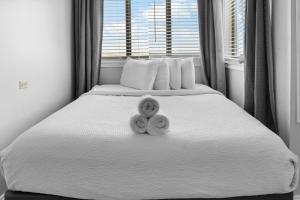 two donuts sitting on a bed in a bedroom at The Palace 2306 in Myrtle Beach