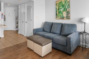 a living room with a blue couch and a table at The Palace 2306 in Myrtle Beach