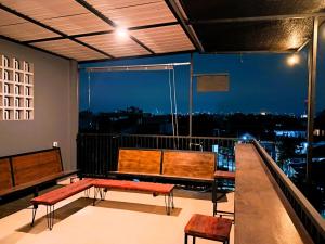 a balcony with benches and a view of a city at Nafaka Hostel and Tours in Malang