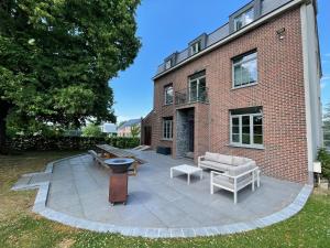 a patio in front of a brick building at La Maison Calestienne in Han-sur-Lesse