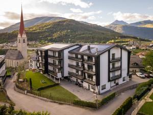 an aerial view of a building with a church at Laurena Aparthotel near Brixen in Natz-Schabs