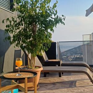 a table and a glass of wine on a balcony at Villa Elmas in Kalkan +35 photos