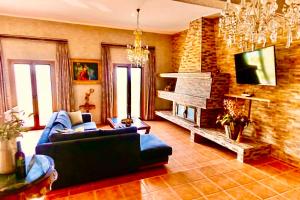 a living room with a couch and a fireplace at VillaAnna in Keratea