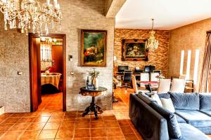 a living room with a couch and a table at VillaAnna in Keratea