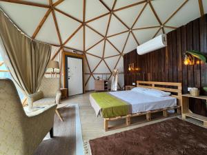 a room with a bed and a chair in a tent at Belek Glamping House in Çakıllık +41 photos