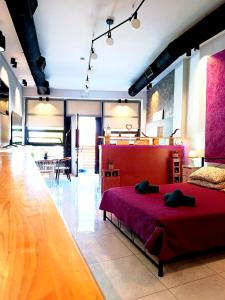 a bedroom with a red bed in a room at Corfu port apartment in Mantoúkion +40 photos