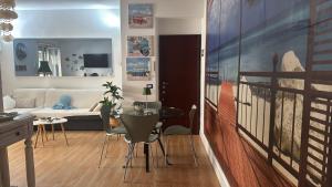 a living room with a couch and a table with chairs at Casa di Roberta in Passoscuro +6 photos