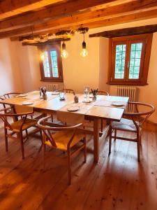 a large wooden table with chairs in a room at Rifugio in Voga in Gordona