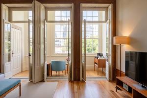a living room with a couch and a tv at Casa do Arquiteto Townhouse - Adults Only in Porto +37 photos