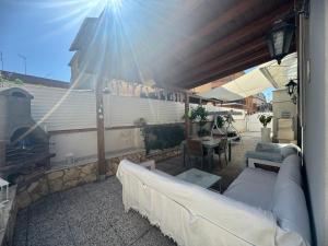 a outdoor patio with a couch and a fireplace at Casa di Roberta in Passoscuro