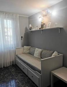 a small bed in a room with a window at Saturn Cozy Stay in Mangalia