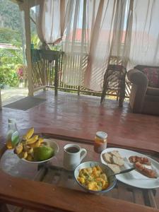 a table with two plates of food on it at anthurium cabin in Trafalgar