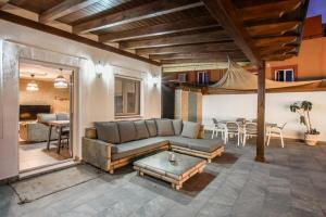 a living room with a couch and a table at Villa del Relax in Corralejo