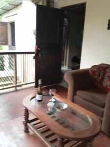 a living room with a table and a couch at anthurium cabin in Trafalgar +13 photos