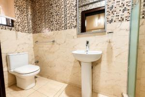 a bathroom with a toilet and a sink at Fadars Place in Sagisa +34 photos