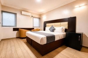 a hotel room with a large bed and a chair at Fadars Place in Sagisa