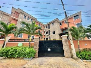 a black gate in front of a building with palm trees at Fadars Place in Sagisa