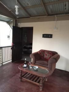 a living room with a couch and a coffee table at anthurium cabin in Trafalgar
