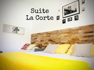 a bedroom with a bed with a yellow blanket at Suite La Corte in Florence +33 photos