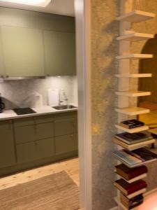 a spiral staircase in a kitchen with books at Hannas hus in Karlskrona