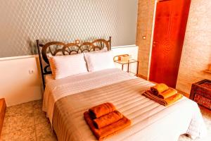 a bedroom with a bed with towels on it at VillaAnna in Keratea