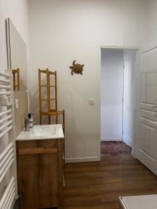 a bathroom with a sink and a glass door at Échappée Méditerranéenne in Lectoure