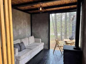 a living room with a couch and a table at Cabañas Bosque Antiguo in Tapalpa +22 photos