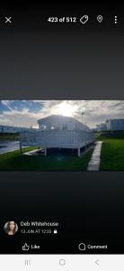 a screenshot of a picture of a white building at 1 The Willows Reighton Sands in Reighton