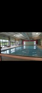 a large empty swimming pool in a building at 1 The Willows Reighton Sands in Reighton