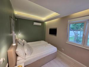 a small bedroom with a bed and a window at Villa Aida in Sarajevo +71 photos