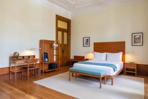 a bedroom with a bed and a table and a desk at Casa do Arquiteto Townhouse - Adults Only in Porto