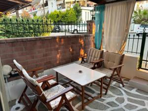 a patio with chairs and a table on a balcony at Evgenias Beach Escape in Kallithea Halkidikis