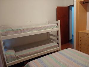 a bedroom with two bunk beds and a bed at La Tranquila in Fernández